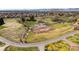 Drone eye view of expansive property with a riding arena and distant mountain views at 12940 W 75Th Ave, Arvada, CO 80005