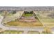 Expansive aerial view showcases the property's open land, horse area, mature trees and proximity to neighborhood at 12940 W 75Th Ave, Arvada, CO 80005