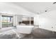 Open basement with a white fireplace, sliding glass door and modern bathtub at 12940 W 75Th Ave, Arvada, CO 80005