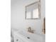Clean bathroom featuring a white vanity, modern gold faucet and a decorative mirror at 12940 W 75Th Ave, Arvada, CO 80005