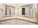 Bathroom featuring double sinks, a large mirror, and vanity lighting at 12940 W 75Th Ave, Arvada, CO 80005