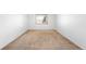 Empty bedroom showcasing wall-to-wall carpet and natural light from the window at 12940 W 75Th Ave, Arvada, CO 80005