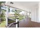 Outdoor deck with wood flooring and black railing, offering scenic views at 12940 W 75Th Ave, Arvada, CO 80005