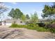 Charming single-story home with lush landscaping and ample parking with an attached garage at 12940 W 75Th Ave, Arvada, CO 80005