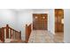 Inviting foyer features beautiful tiled floors and double doors, adding warmth and sophistication to the space at 12940 W 75Th Ave, Arvada, CO 80005