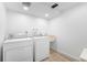 Bright laundry room with updated washer and dryer and modern sink at 12940 W 75Th Ave, Arvada, CO 80005