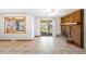 Cozy living room with a brick fireplace, a large window, and sliding door access to the backyard at 12940 W 75Th Ave, Arvada, CO 80005