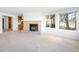 Spacious living room featuring a fireplace and large windows offering ample natural light at 12940 W 75Th Ave, Arvada, CO 80005