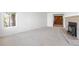 Large living room showcasing a brick fireplace, wood doors and neutral carpet at 12940 W 75Th Ave, Arvada, CO 80005