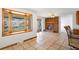 Inviting living room features a brick fireplace and a large window, offering natural light and charm at 12940 W 75Th Ave, Arvada, CO 80005