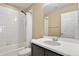 Bright bathroom featuring a tiled shower-tub combo and a modern single sink vanity at 6404 Dry Fork Dr, Frederick, CO 80516