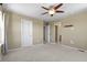 Bedroom with ceiling fan and carpeted floors, and multiple doorways at 6404 Dry Fork Dr, Frederick, CO 80516