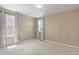 Well-lit bedroom featuring neutral walls, carpet and natural light from the two windows at 6404 Dry Fork Dr, Frederick, CO 80516