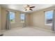 Bedroom with ceiling fan, neutral walls, and window views at 6404 Dry Fork Dr, Frederick, CO 80516