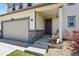 Close up exterior shot of the front entrance showing the porch, stonework and two-car garage at 6404 Dry Fork Dr, Frederick, CO 80516