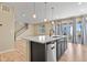 Modern kitchen featuring an island with a sink, a dishwasher, and hardwood floors at 6404 Dry Fork Dr, Frederick, CO 80516
