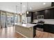 Modern kitchen featuring an island with quartz countertops and stainless steel appliances at 6404 Dry Fork Dr, Frederick, CO 80516