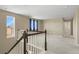 Second floor landing with views from the window and carpeted flooring at 6404 Dry Fork Dr, Frederick, CO 80516