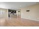 Open concept living area with dark kitchen cabinets, stainless appliances, and light wood floors at 6404 Dry Fork Dr, Frederick, CO 80516