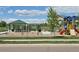 Neighborhood playground with swings, a slide, picnic tables and views of the mountains in the background at 6404 Dry Fork Dr, Frederick, CO 80516