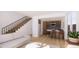Bright living room with open floor plan, staircase, modern kitchen and stainless steel appliances at 789 E County Line Rd, Erie, CO 80516