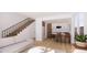 Bright living room with open floor plan, staircase, modern kitchen and stainless steel appliances at 789 E County Line Rd, Erie, CO 80516