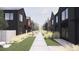 Modern homes line a pedestrian walkway with lush landscaping, creating a tranquil and community-focused street at 789 E County Line Rd, Erie, CO 80516