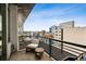 Relaxing balcony area featuring a comfortable chair and table, perfect for enjoying city views at 1401 Wewatta St # 911, Denver, CO 80202