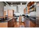 Modern kitchen with stainless steel appliances, granite countertops, and light wood cabinets, complemented by track lighting at 1401 Wewatta St # 911, Denver, CO 80202