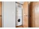 A compact laundry closet features a stacked washer and dryer unit, maximizing space efficiency at 1401 Wewatta St # 911, Denver, CO 80202