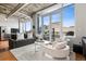 Modern living room with large windows, concrete ceilings, and stylish furniture at 1401 Wewatta St # 911, Denver, CO 80202