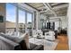 Contemporary living area featuring a balcony, modern seating, and a view at 1401 Wewatta St # 911, Denver, CO 80202