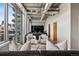 Bright living room with concrete ceilings, complemented by a wall of windows offering city views and natural light at 1401 Wewatta St # 911, Denver, CO 80202