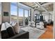 Stylish living room with floor-to-ceiling windows, balcony, and concrete ceilings, creating an industrial modern aesthetic at 1401 Wewatta St # 911, Denver, CO 80202