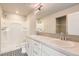 Bright bathroom with double sinks, quartz counters, walk-in shower, and black and white patterned tile flooring at 523 Beckwourth Ave, Fort Lupton, CO 80621