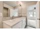A bathroom with double sinks, a large mirror and views into the bedroom and walk-in closet at 523 Beckwourth Ave, Fort Lupton, CO 80621