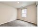 A standard carpeted bedroom with a window with exterior views at 523 Beckwourth Ave, Fort Lupton, CO 80621
