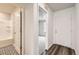 An open hallway showcasing entrances to a bathroom and bedroom and two styles of flooring at 523 Beckwourth Ave, Fort Lupton, CO 80621