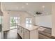 Open kitchen featuring stainless appliances, stone countertop island, and an adjacent dining area at 523 Beckwourth Ave, Fort Lupton, CO 80621