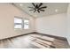 Bright, open living area with ceiling fan and two windows for plenty of natural light at 523 Beckwourth Ave, Fort Lupton, CO 80621