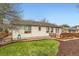 Exterior of home with backyard deck, manicured lawn, and mature landscaping providing privacy at 741 Hallmark Ln, Longmont, CO 80504