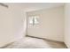 Bright bedroom with neutral carpet, natural light from a window, and fresh white walls at 741 Hallmark Ln, Longmont, CO 80504