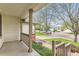 Covered front porch view looking out at the peaceful neighborhood street at 741 Hallmark Ln, Longmont, CO 80504