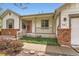 Inviting front porch with brick accents and a meticulously landscaped garden bed at 741 Hallmark Ln, Longmont, CO 80504