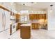 Kitchen featuring light wood cabinets, an island, and stainless steel appliances at 741 Hallmark Ln, Longmont, CO 80504