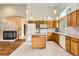 Bright kitchen with wooden cabinetry, a kitchen island, and stainless steel appliances at 741 Hallmark Ln, Longmont, CO 80504