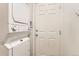 Compact laundry area with a stacked washer and dryer and a practical utility door at 741 Hallmark Ln, Longmont, CO 80504