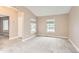 Neutral living room featuring carpet, large windows, and freshly painted walls at 741 Hallmark Ln, Longmont, CO 80504