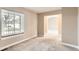 Neutral living room with carpet, large windows, and view to other rooms at 741 Hallmark Ln, Longmont, CO 80504
