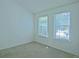 Minimalist bedroom with neutral carpeting, bright windows, and ample natural light at 9669 W Chatfield Ave # A, Littleton, CO 80128